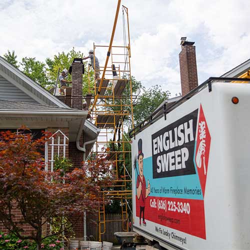 English Sweep Chimney truck with logo scaffolding  one man on roof and one on scaffolding