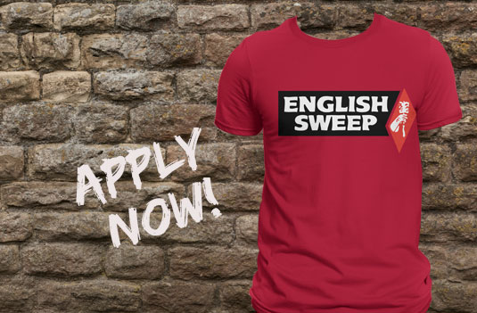 Join Our Team red English Sweep Shirt rock wall in background and apply now is written on wall.