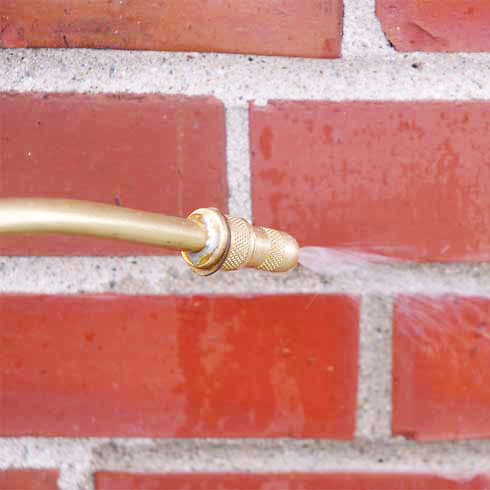 Water Repellent Spray on red bricks with applicator