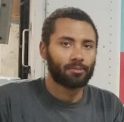 Nate Mersch - Apprentice Trainer (2015) short black hair mustache and shorter beard in the warehouse