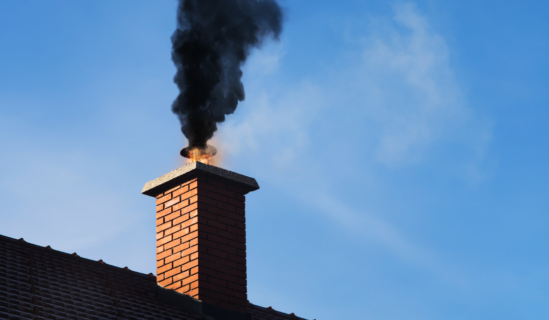 black smoke and sparks coming out of a masonry chimney