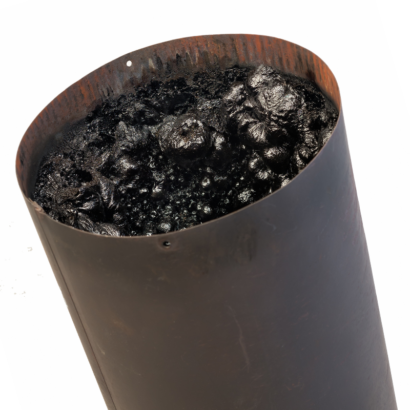 black, tar-like creosote in a brown, round flue