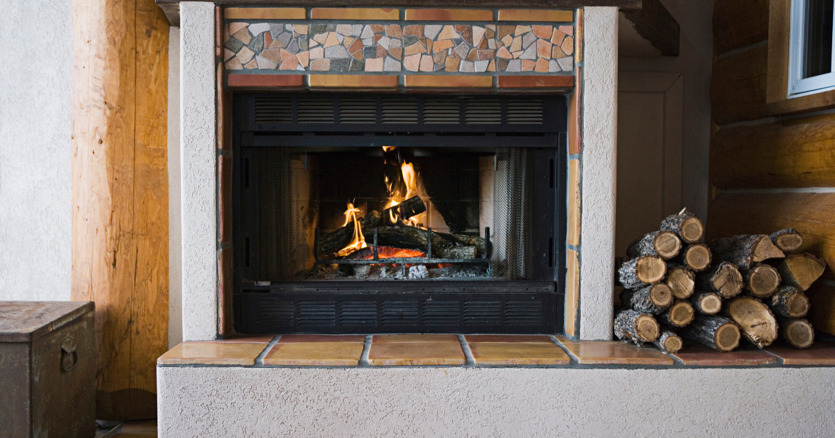 We sell only quality products-a wood-powered fireplace insert with a pile of logs next to it.