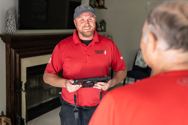 Technician smiling while talking to a client