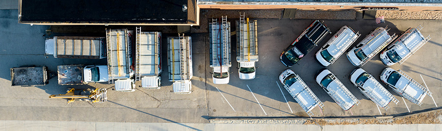 Bird's eye view of English Sweep vans at their office.  They all have ladders on top.