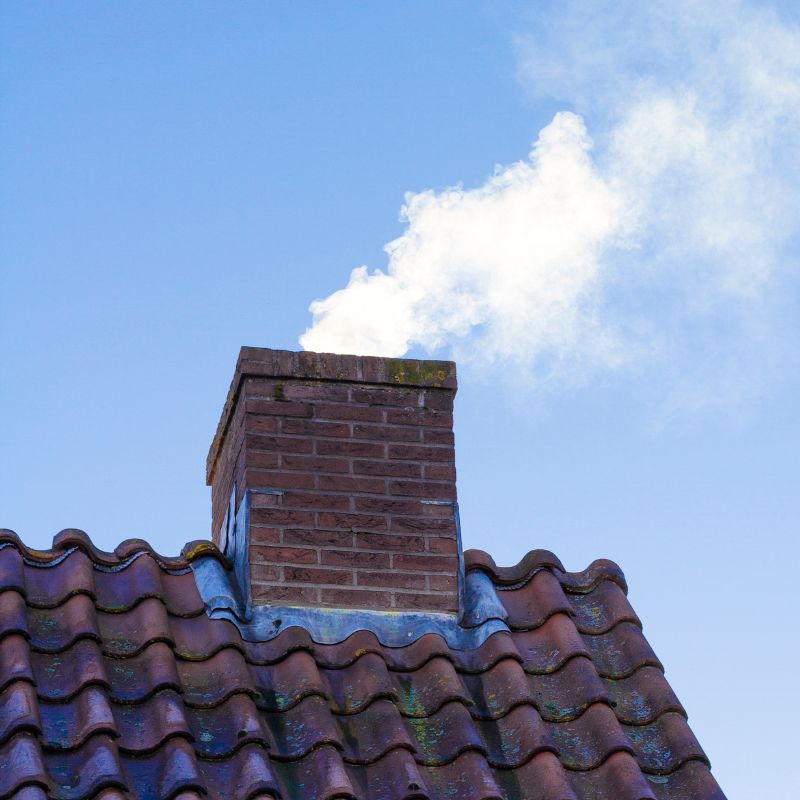 masonry chimney with smoke coming out